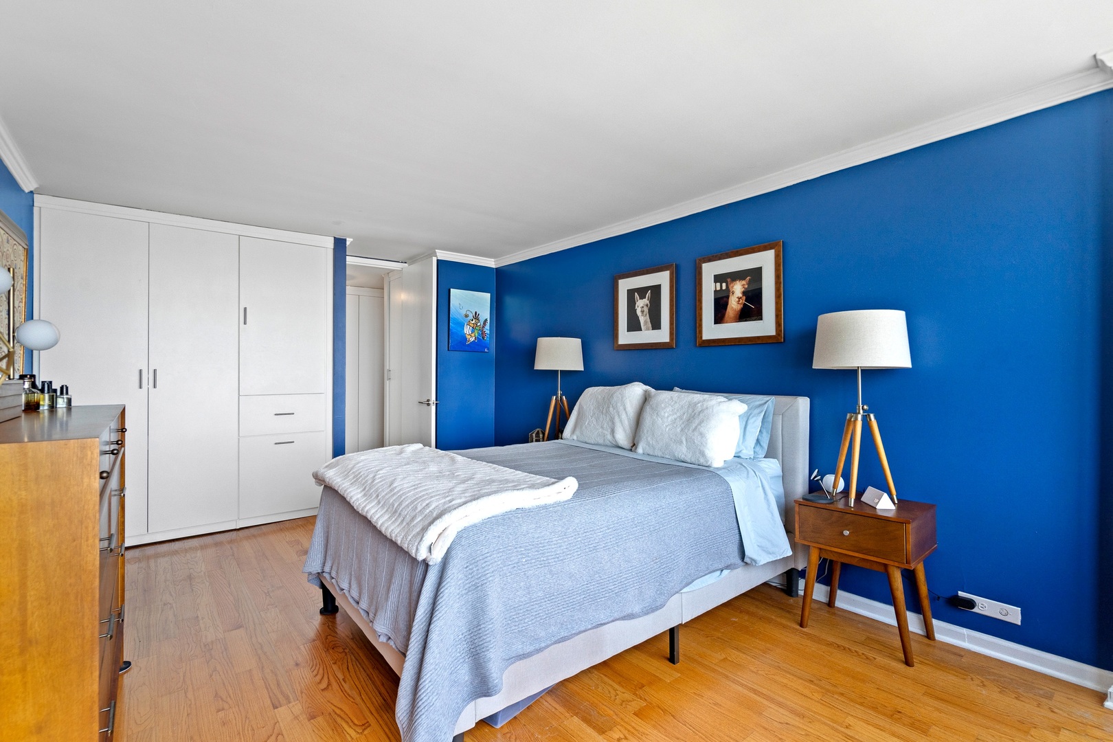 655 West Irving Park Road, Unit 3608 Chicago, IL 60613 - Photo 16 of 37 a spacious bedroom with a bed and a lamp on table