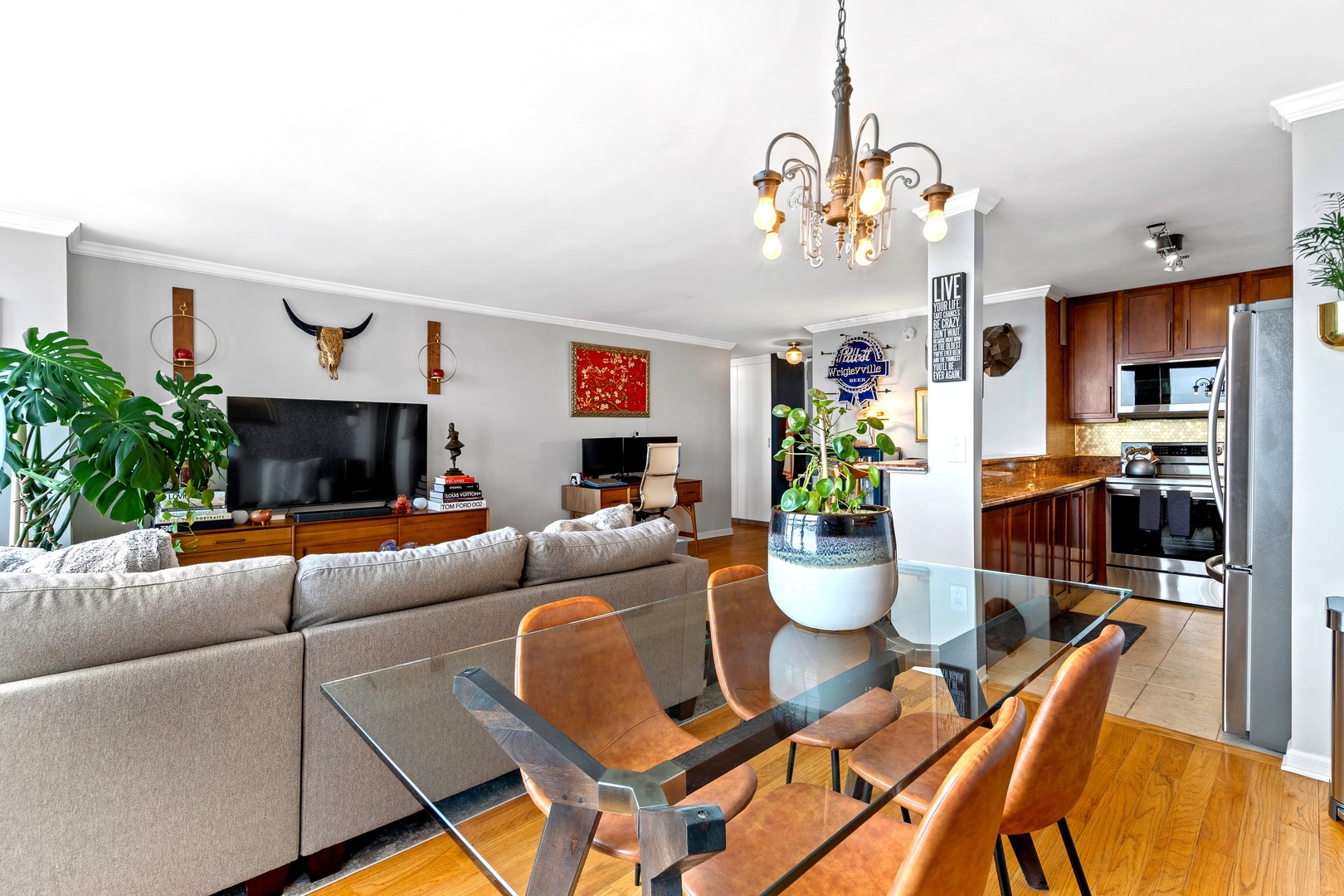 655 West Irving Park Road, Unit 3608 Chicago, IL 60613 - Photo 5 of 37 a living room with furniture and a chandelier