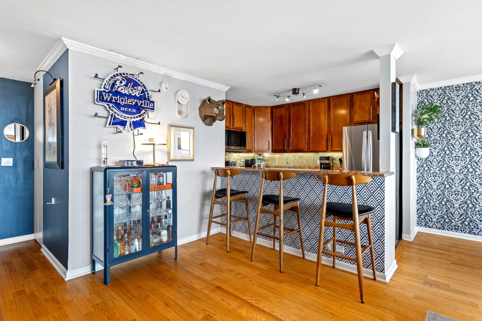 655 West Irving Park Road, Unit 3608 Chicago, IL 60613 - Photo 6 of 37 a open kitchen with stainless steel appliances granite countertop a refrigerator a stove top oven a dining table and chairs with wooden floor