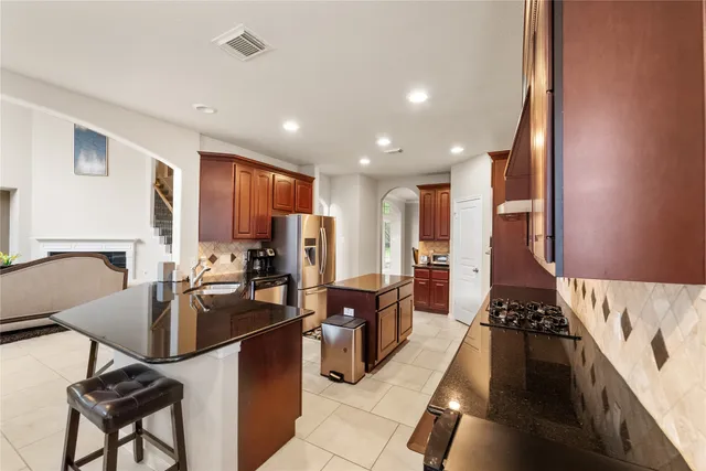 a living room with furniture a flat screen tv and a table