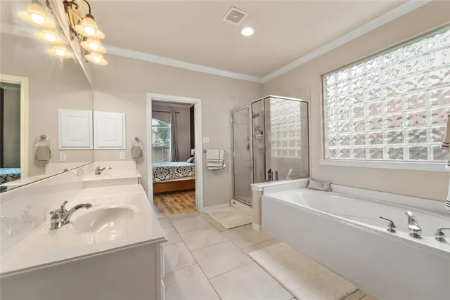 a bathroom with a tub sink and mirror