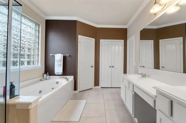 a spacious bathroom with a sink a mirror and a shower