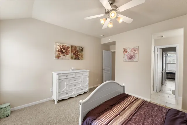 a bedroom with a large bed and a large window