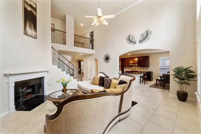 a living room with furniture a fireplace and a flat screen tv