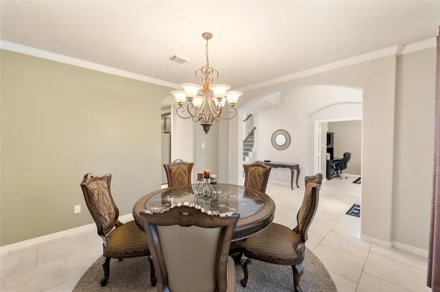 a dining room with furniture and chandelier