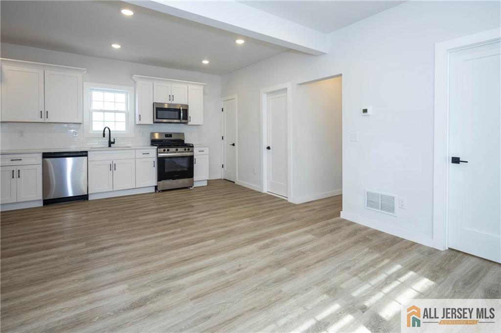 27 South 2nd Street Fords, NJ 08863 - Photo 12 of 33 a kitchen with stainless steel appliances a refrigerator and a stove top oven