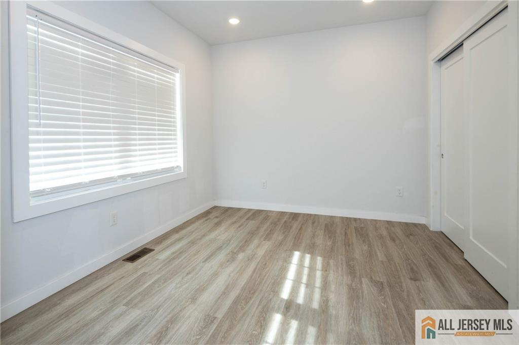 27 South 2nd Street Fords, NJ 08863 - Photo 14 of 33 a view of an empty room and wooden floor and a window