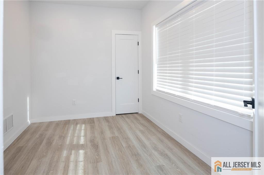 27 South 2nd Street Fords, NJ 08863 - Photo 15 of 33 a view of an empty room with wooden floor and a window
