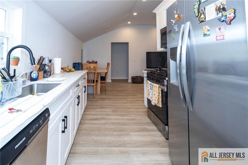 27 South 2nd Street Fords, NJ 08863 - Photo 19 of 33 a kitchen with stainless steel appliances granite countertop a refrigerator and a stove