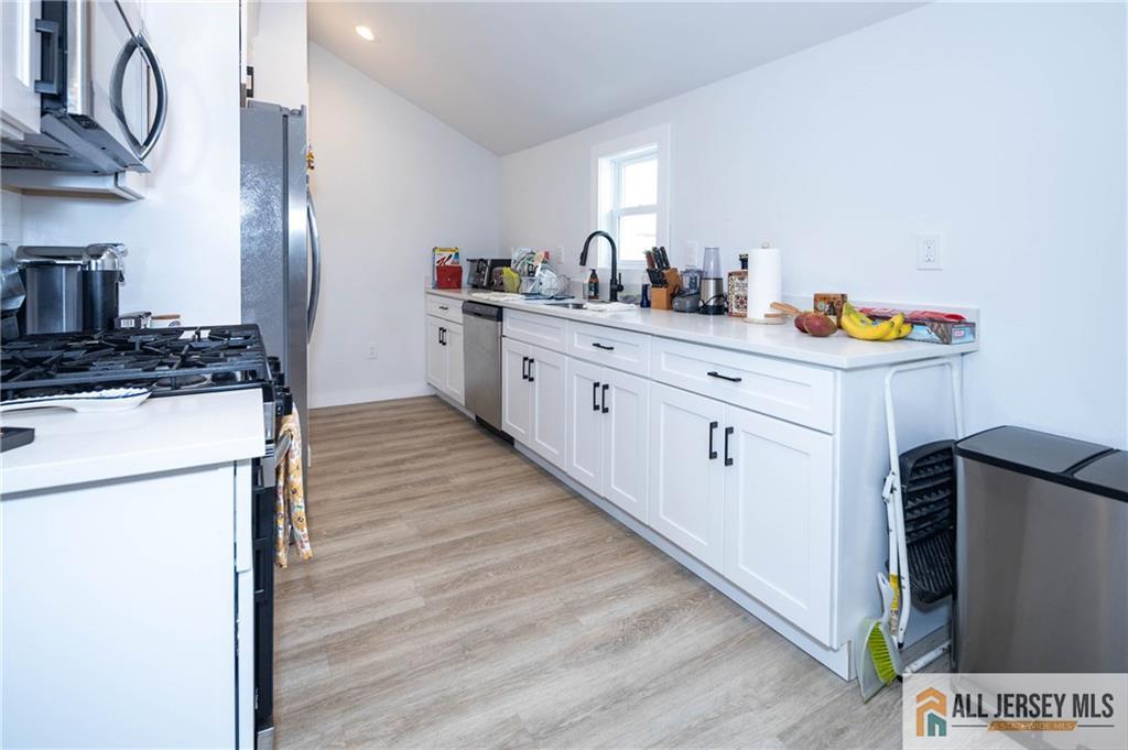 27 South 2nd Street Fords, NJ 08863 - Photo 20 of 33 a kitchen with a sink a refrigerator and cabinets