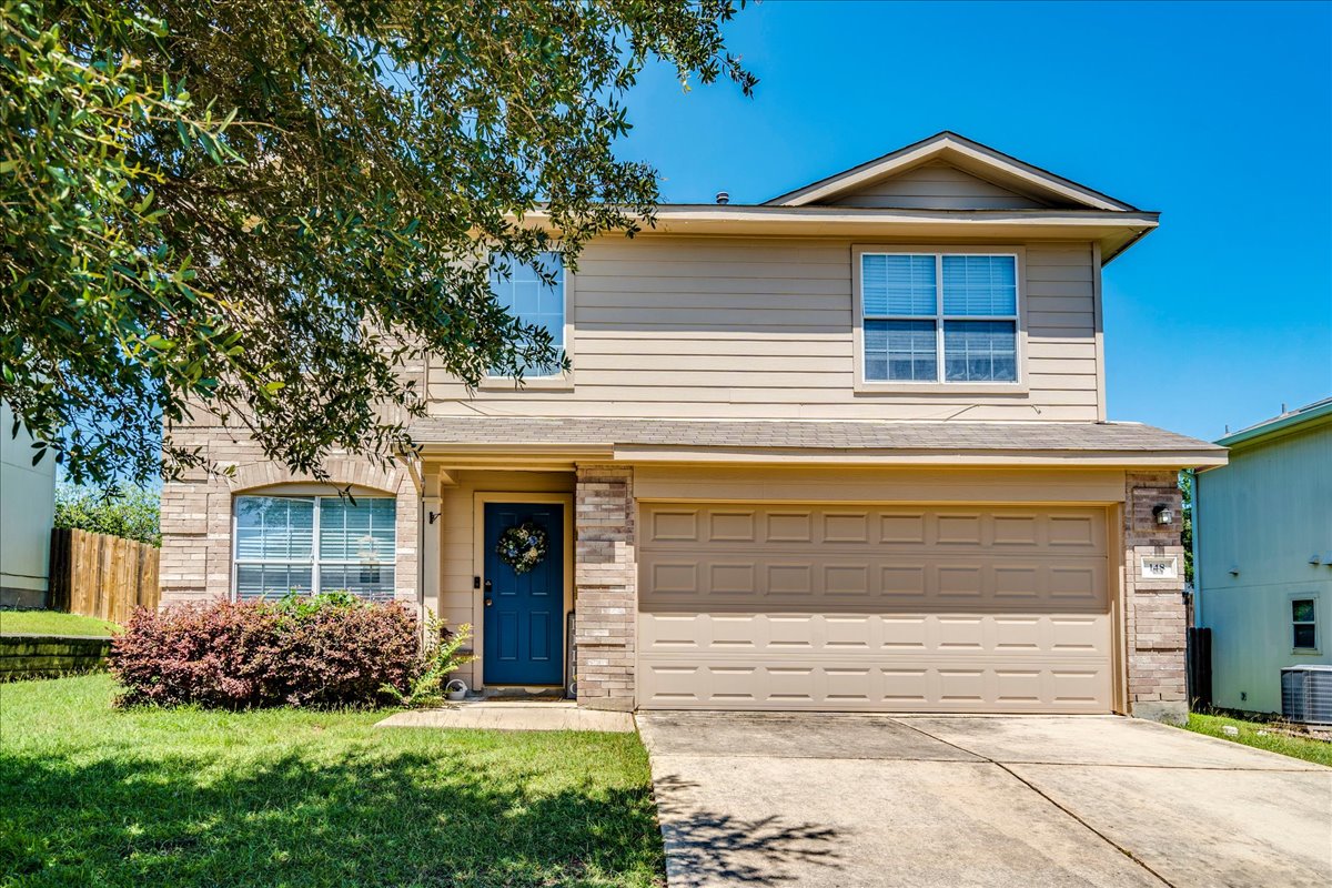 148 Buttercup Way Kyle, TX 78640 - Photo 1 of 33 A welcoming facade with a mix of brick and siding, complemented by a neatly kept lawn.