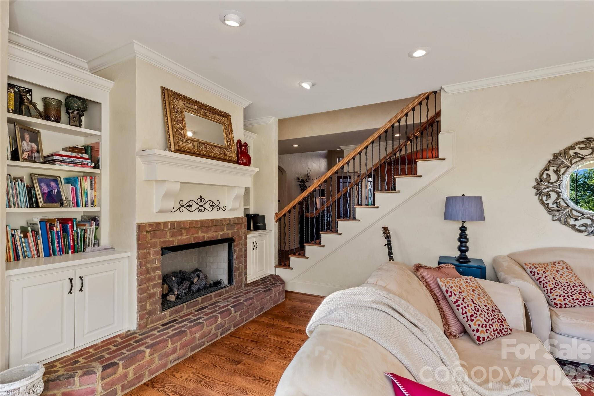 368 Players Ridge Road Hickory, NC 28601 - Photo 11 of 48 a living room with fireplace furniture and a book shelf