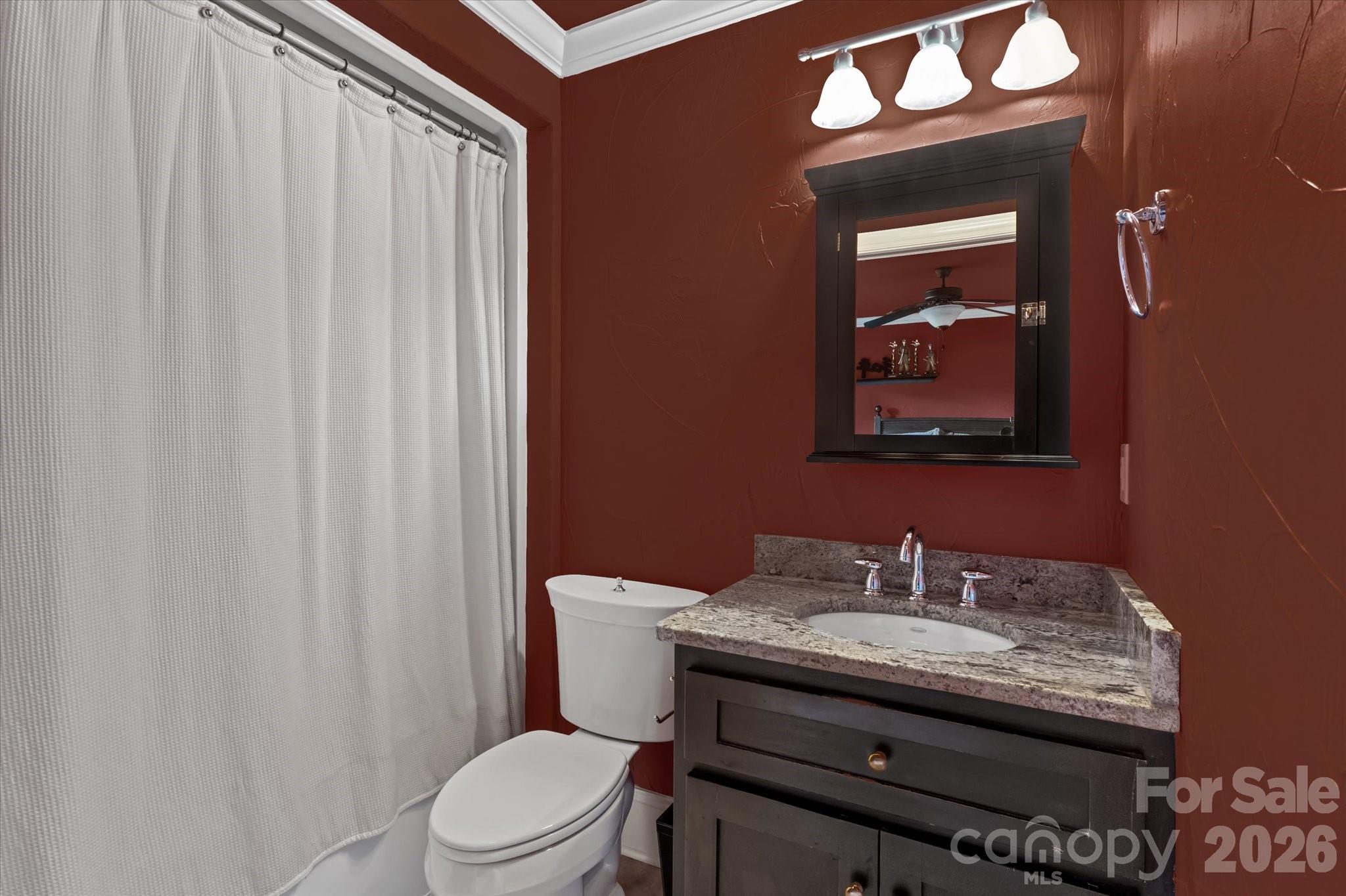 368 Players Ridge Road Hickory, NC 28601 - Photo 25 of 48 a bathroom with a granite countertop toilet a sink and a mirror