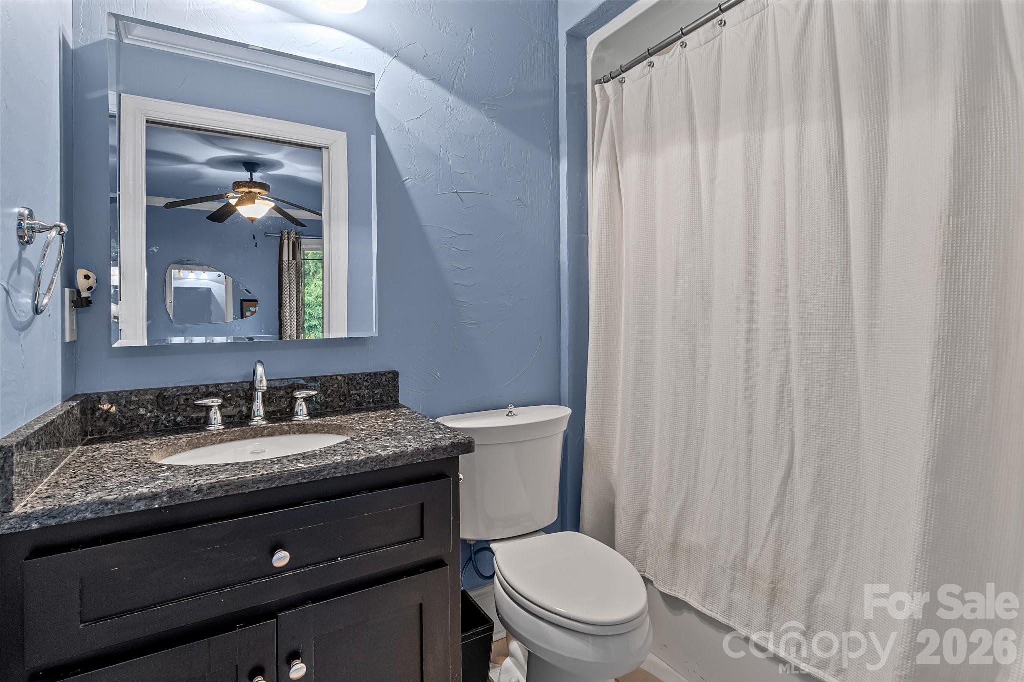 368 Players Ridge Road Hickory, NC 28601 - Photo 27 of 48 a bathroom with a granite countertop sink toilet and mirror
