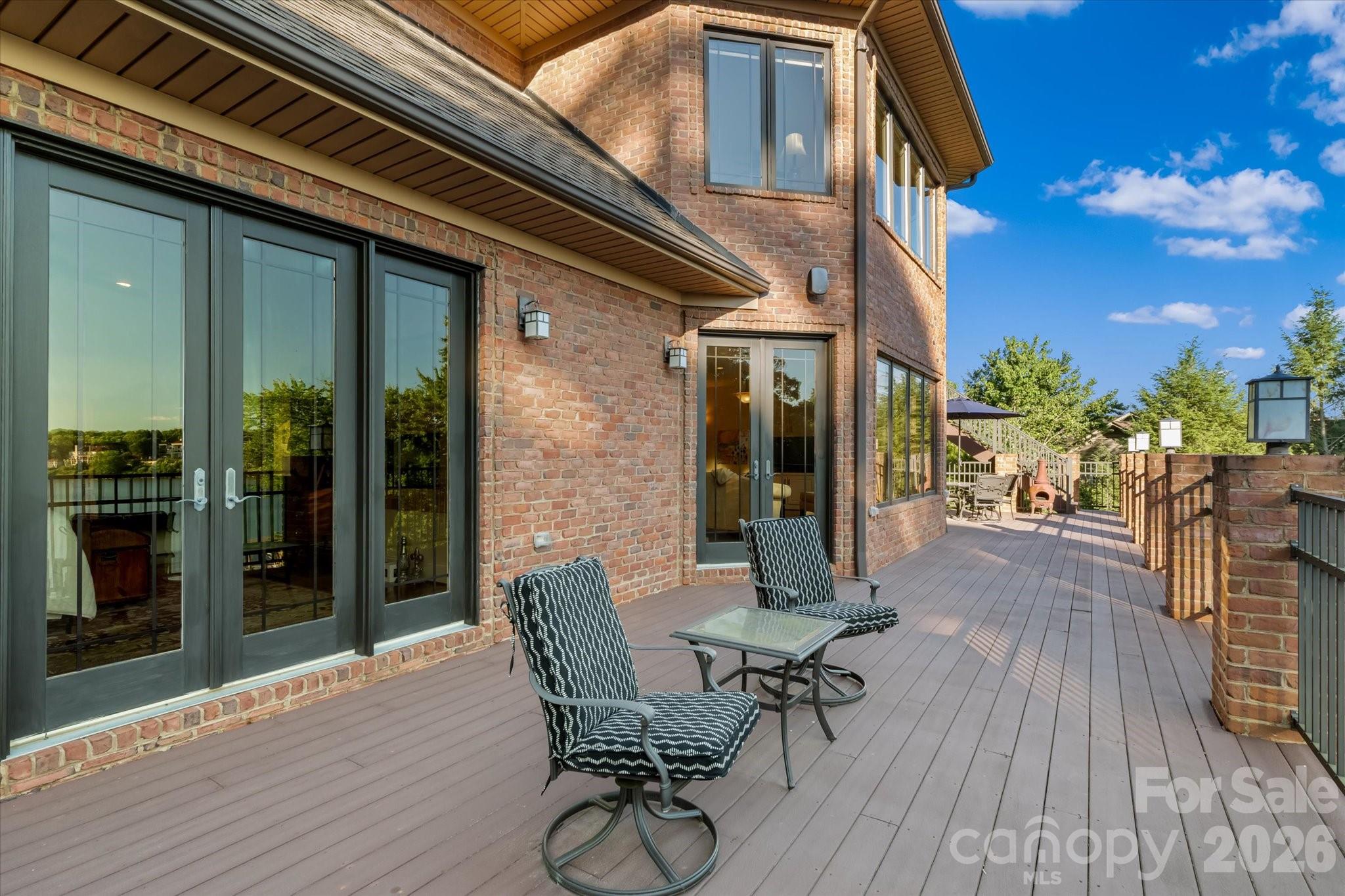 368 Players Ridge Road Hickory, NC 28601 - Photo 39 of 48 a view of a patio with table and chairs with wooden floor and fence