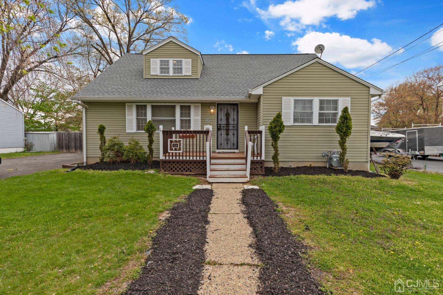 a front view of a house with a garden