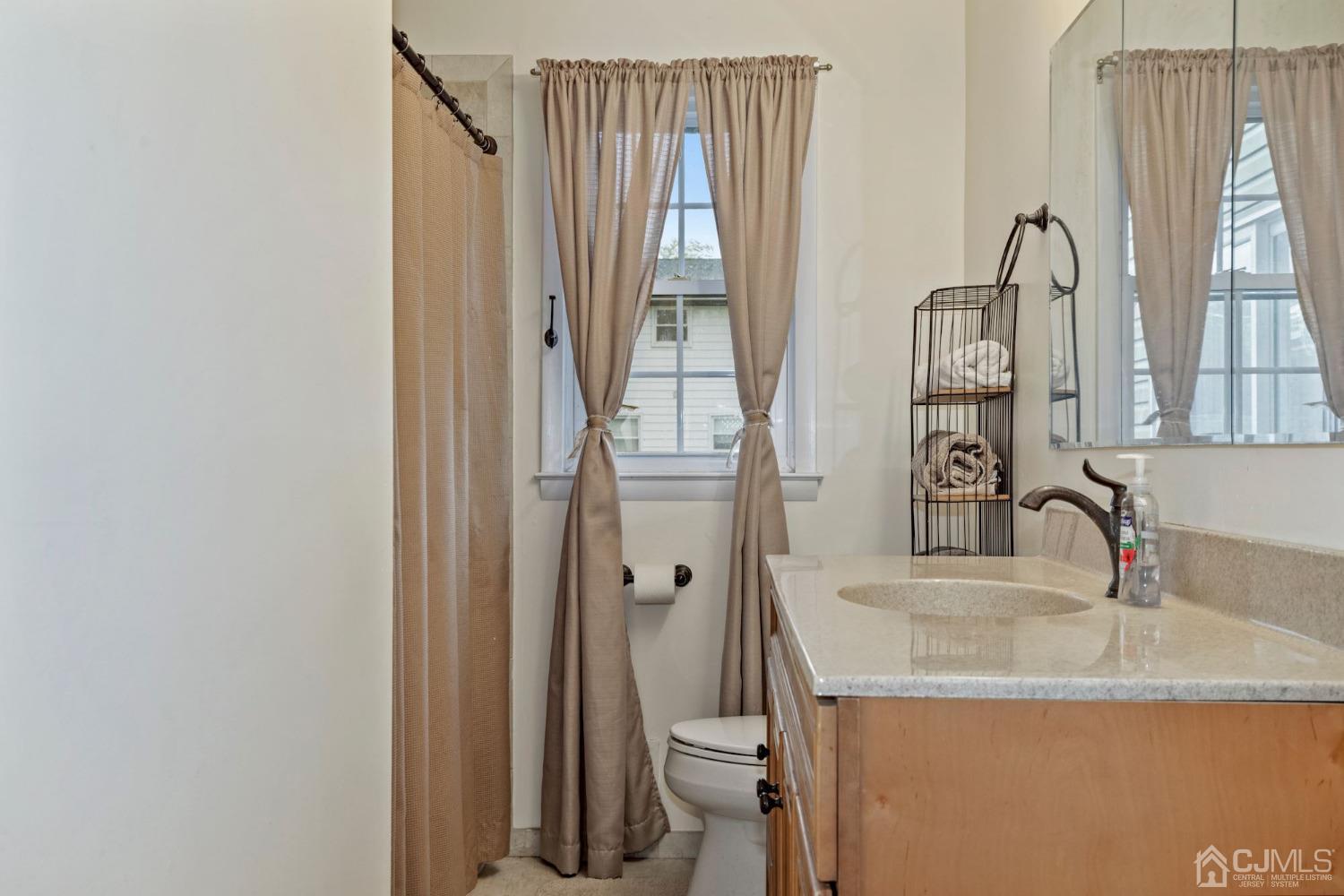 59 Clipper Avenue Edison, NJ 08817 - Photo 15 of 29 a bathroom with a granite countertop sink and a mirror