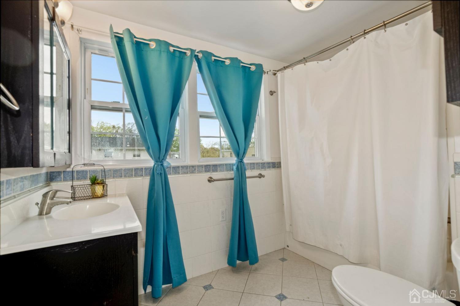 59 Clipper Avenue Edison, NJ 08817 - Photo 19 of 29 a bathroom with a sink a toilet and a mirror