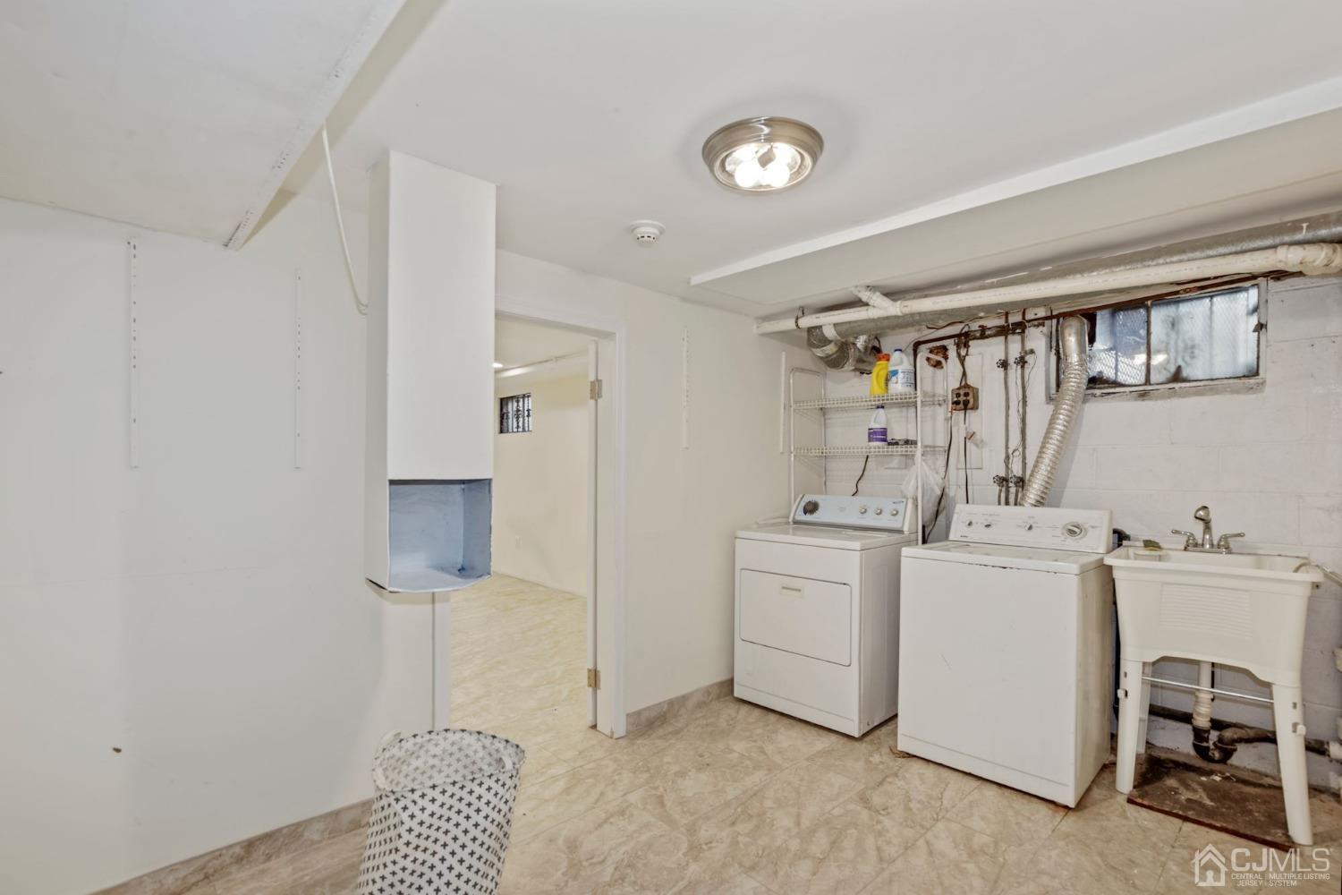 59 Clipper Avenue Edison, NJ 08817 - Photo 20 of 29 a kitchen with a refrigerator and white cabinets