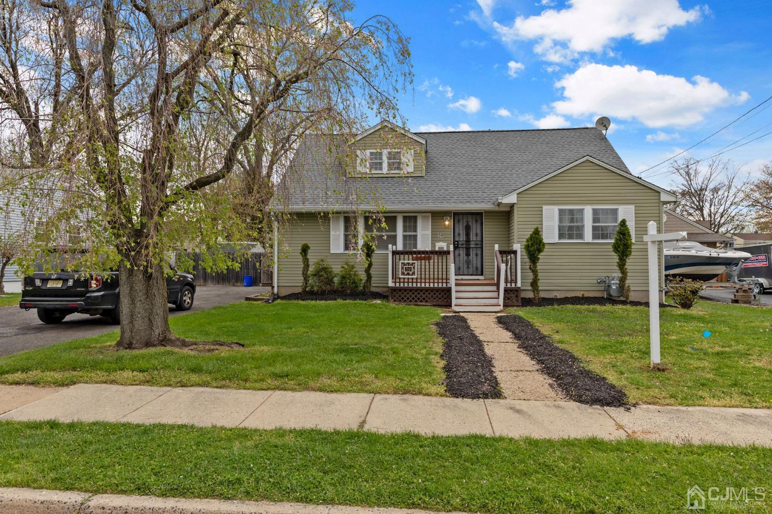 59 Clipper Avenue Edison, NJ 08817 - Photo 2 of 29 a front view of a house with a garden and trees