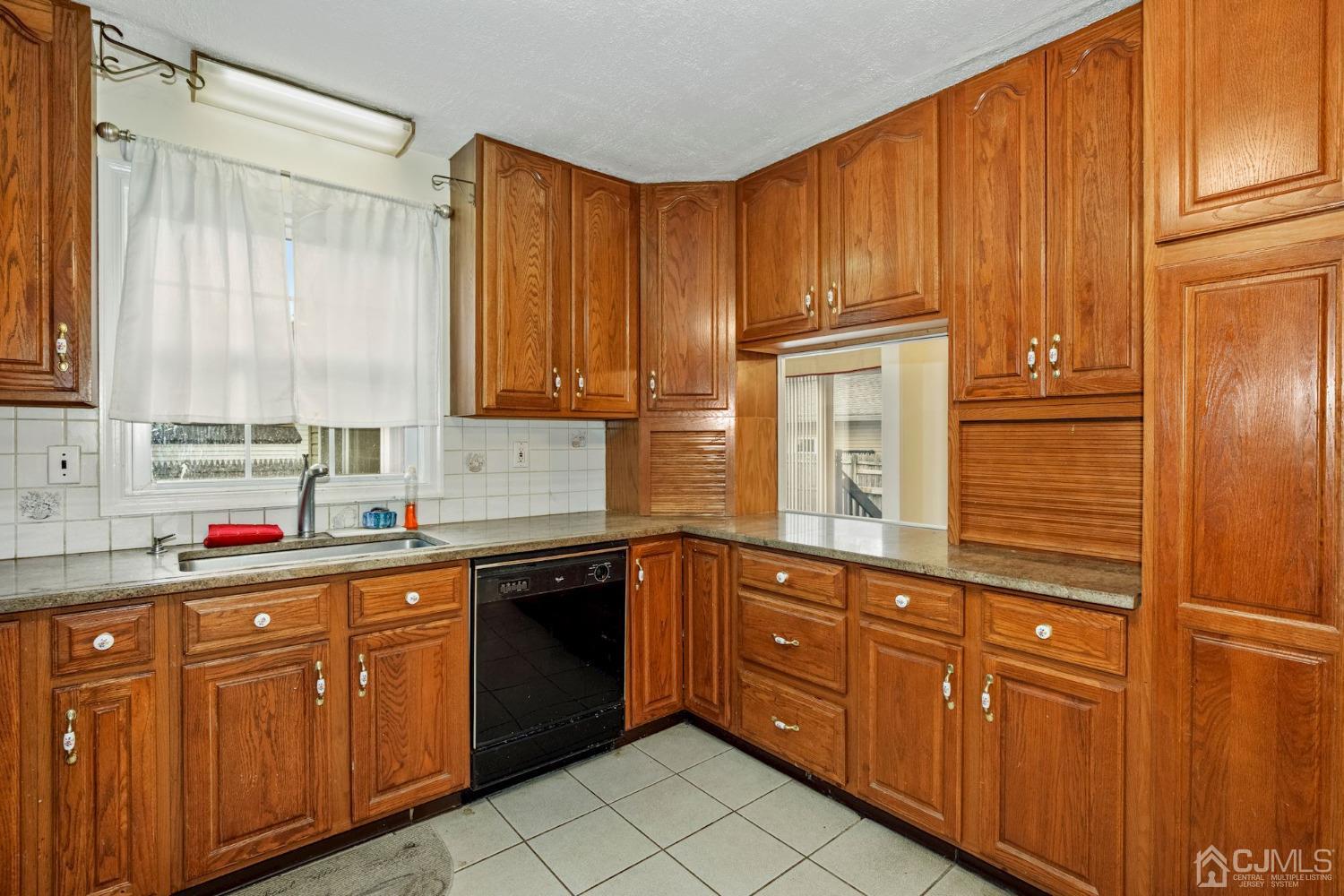 59 Clipper Avenue Edison, NJ 08817 - Photo 3 of 29 a kitchen with stainless steel appliances granite countertop cabinets and window