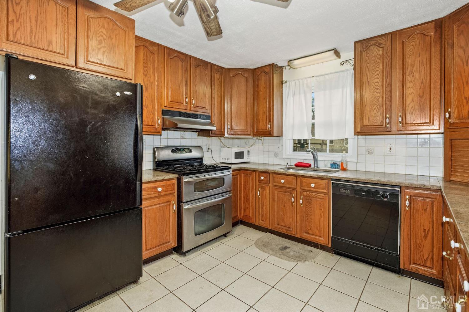 59 Clipper Avenue Edison, NJ 08817 - Photo 4 of 29 a kitchen with stainless steel appliances granite countertop a refrigerator sink and cabinets