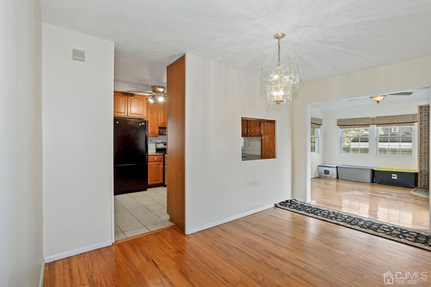 59 Clipper Avenue Edison, NJ 08817 - Photo 8 of 29 a view of a hallway with wooden floor and a living room