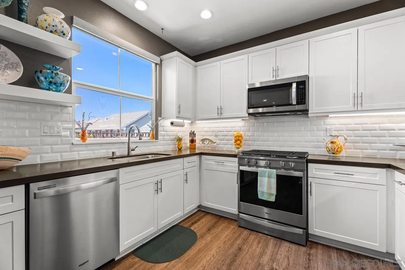 4326 Star Path Way, Unit 1 Oceanside, CA 92056 - Photo 18 of 46 a kitchen with white cabinets stainless steel appliances and sink