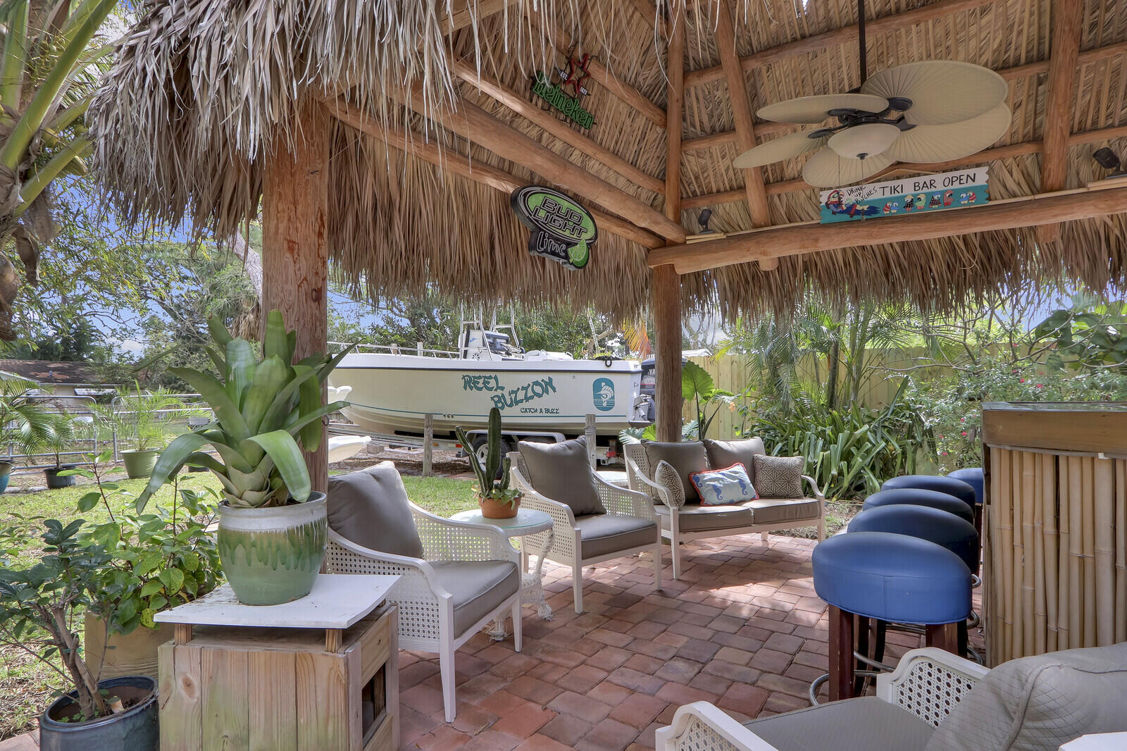 503 North Perry Avenue Jupiter, FL 33458 - Photo 11 of 44 a view of a patio with table and chairs potted plants and palm tree
