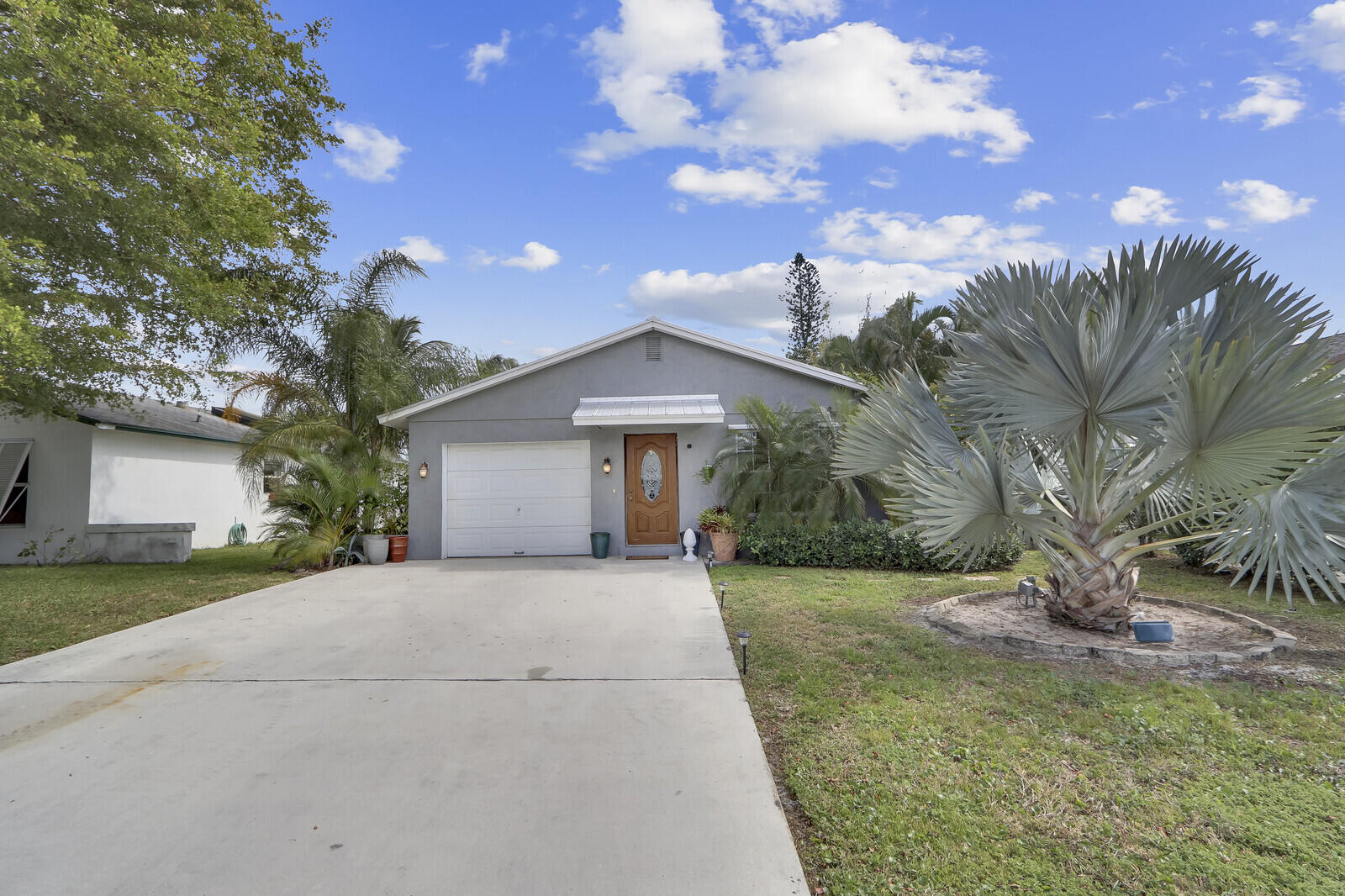 503 North Perry Avenue Jupiter, FL 33458 - Photo 16 of 44 a front view of a house with a yard and garage