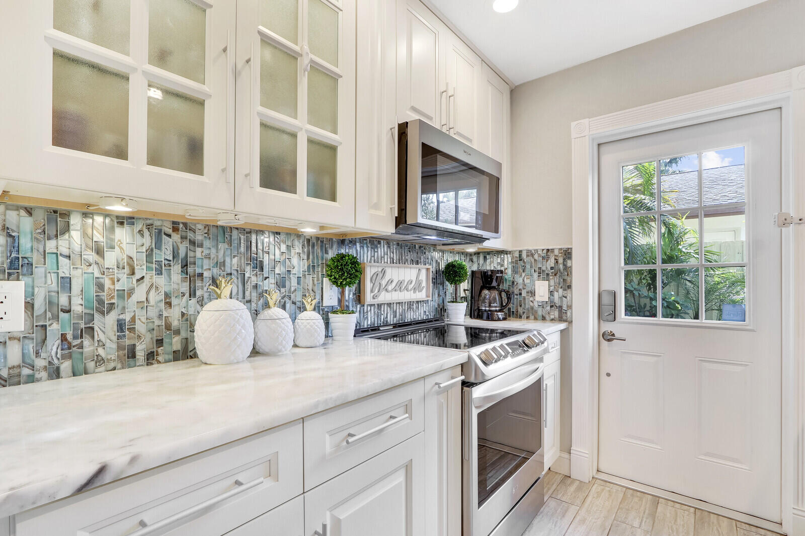 503 North Perry Avenue Jupiter, FL 33458 - Photo 2 of 44 a kitchen with stainless steel appliances white cabinets and a stove top oven