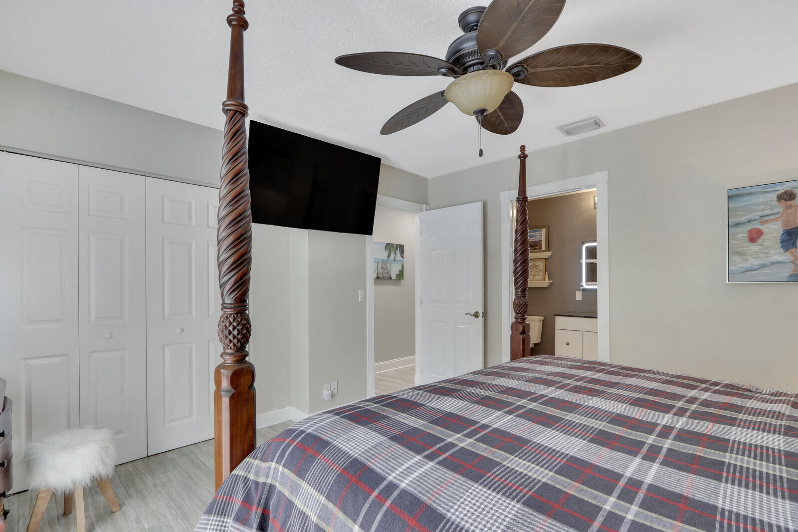 503 North Perry Avenue Jupiter, FL 33458 - Photo 25 of 44 a bedroom with a bed ceiling fan and a wooden floor