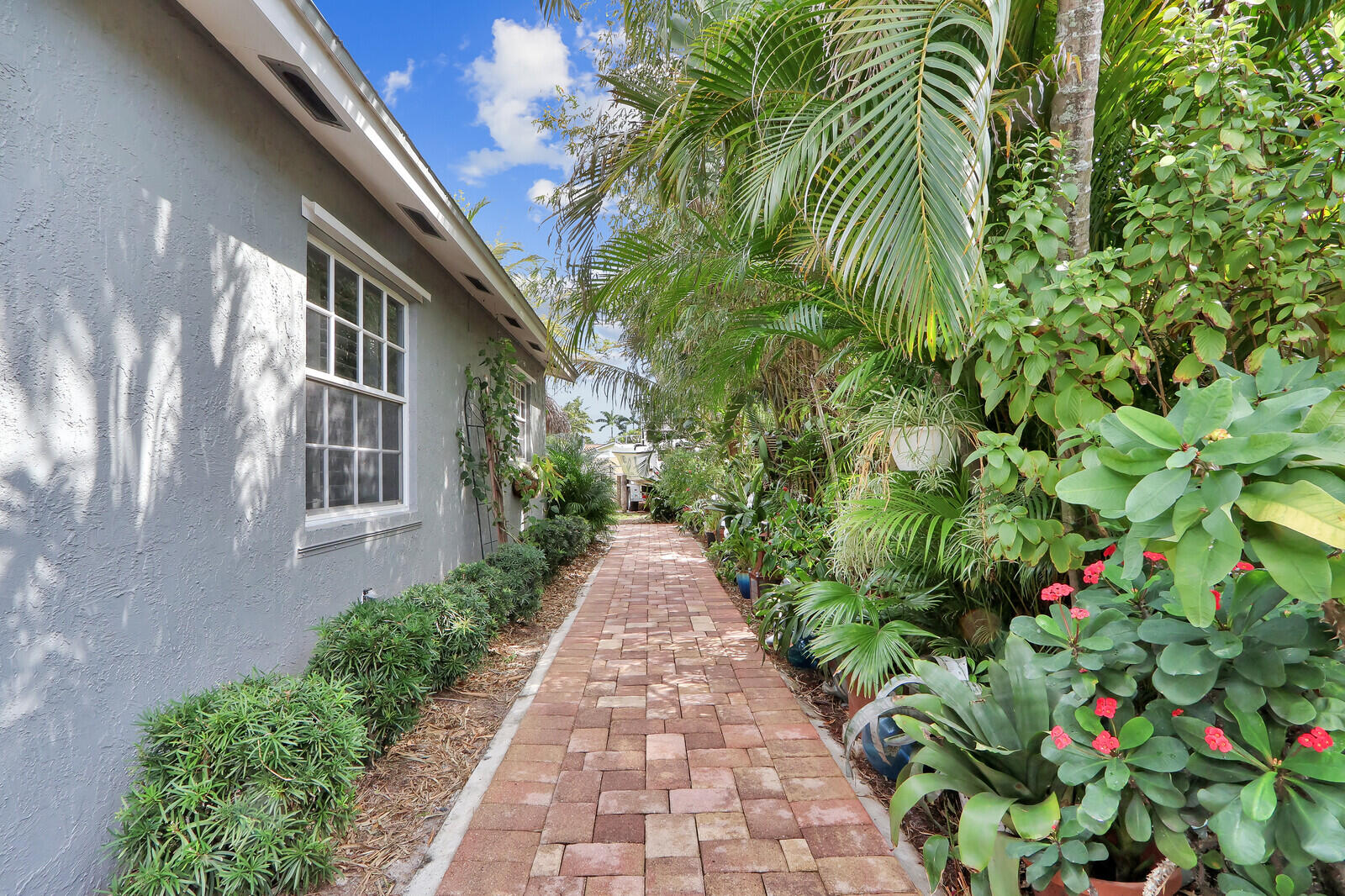503 North Perry Avenue Jupiter, FL 33458 - Photo 27 of 44 a view of a pathway that has potted plants