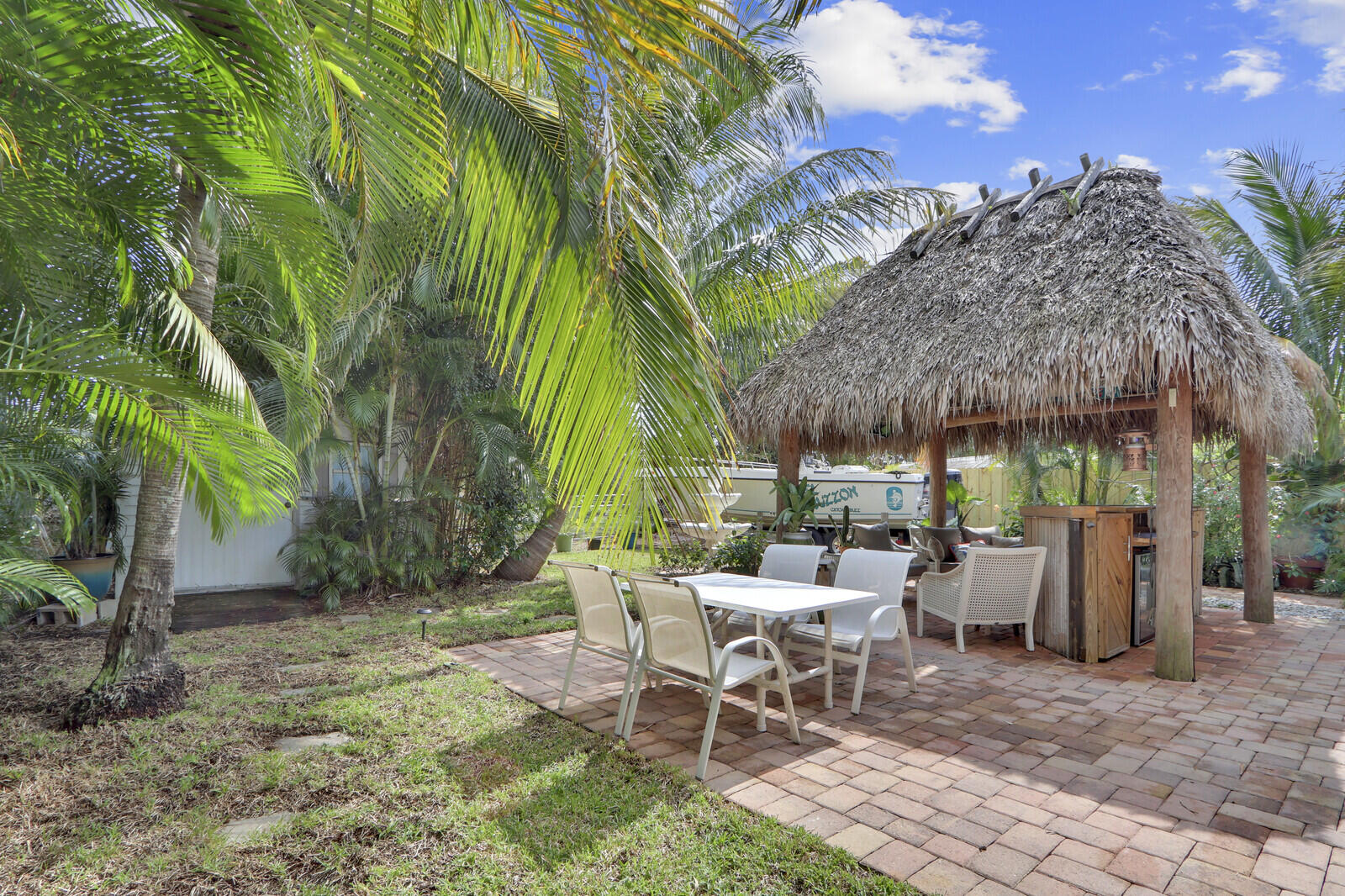 503 North Perry Avenue Jupiter, FL 33458 - Photo 31 of 44 a view of a chairs and table in backyard