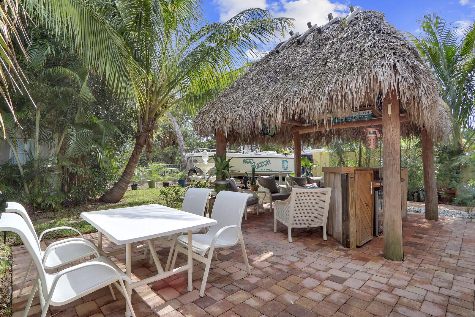 503 North Perry Avenue Jupiter, FL 33458 - Photo 32 of 44 a patio with a table and chairs and a barbeque