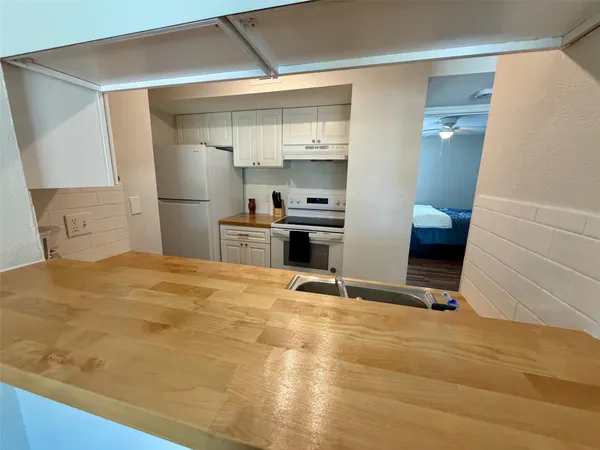 a room with a bed and cabinets