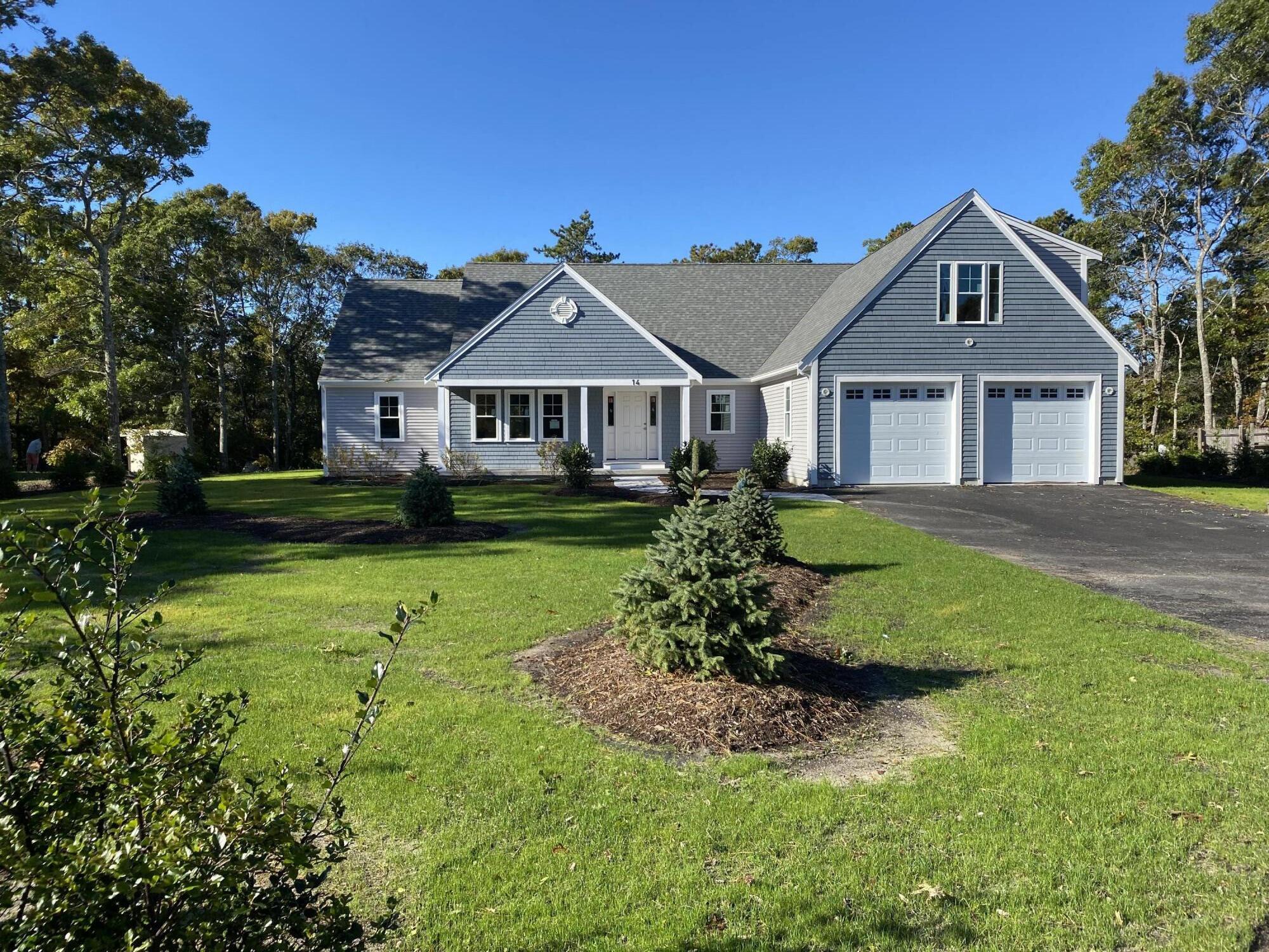 14 Southwind Circle Mashpee, MA 02649 - Photo 1 of 3 a front view of a house with a yard and potted plants