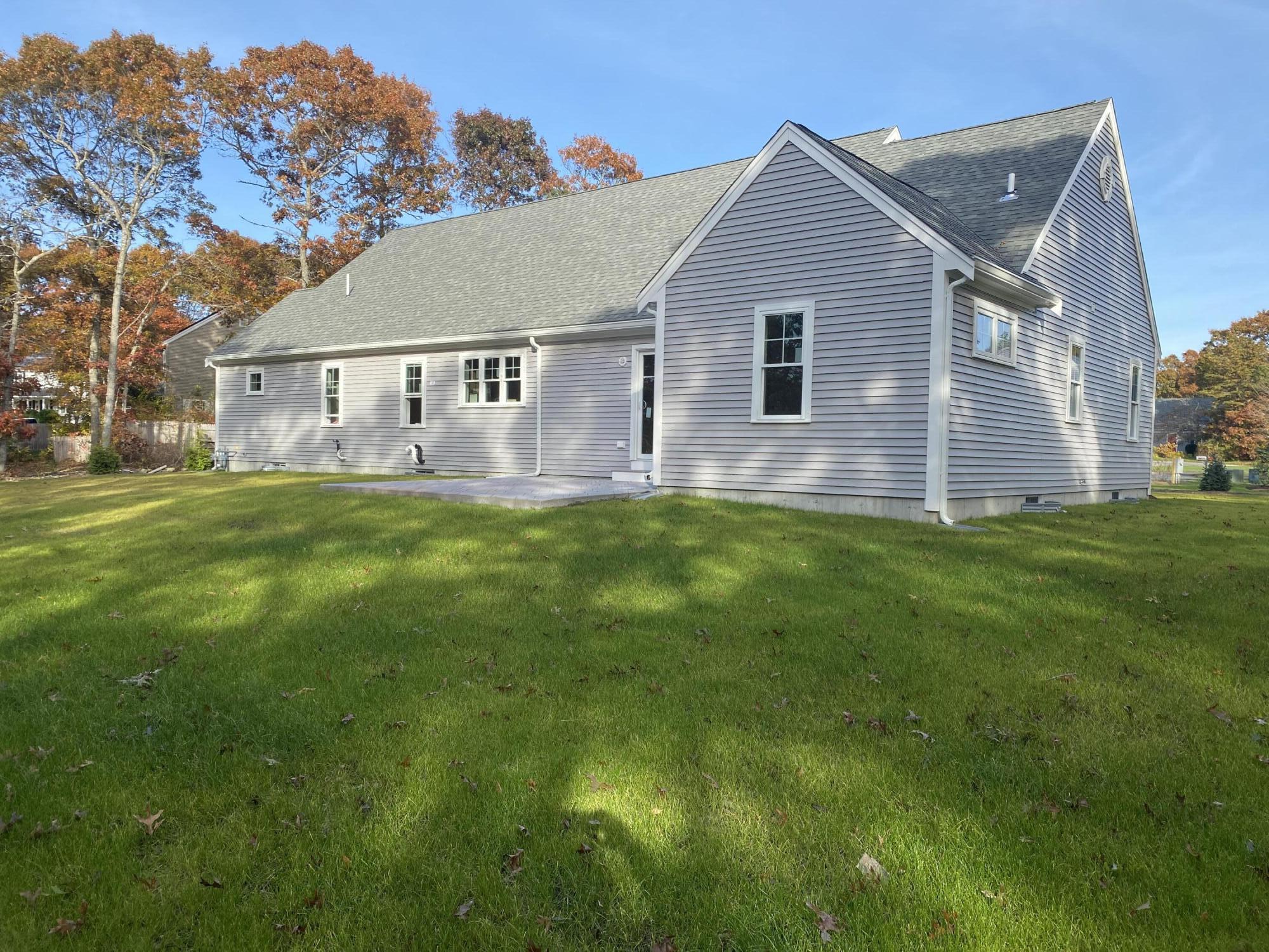 14 Southwind Circle Mashpee, MA 02649 - Photo 2 of 3 a front view of house with yard and green space