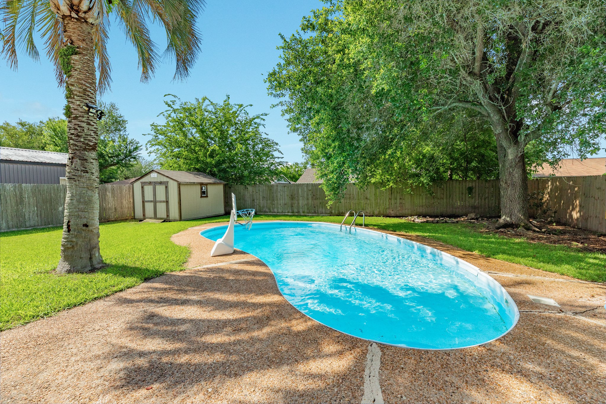 128 Houston Street Angleton, TX 77515 - Photo 5 of 25 a view of a swimming pool with a patio