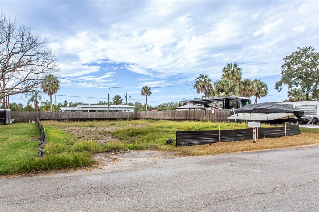 6813 Garden Drive New Port Richey, FL 34652 - Photo 6 of 8 a view of a swimming pool with an outdoor seating and a yard