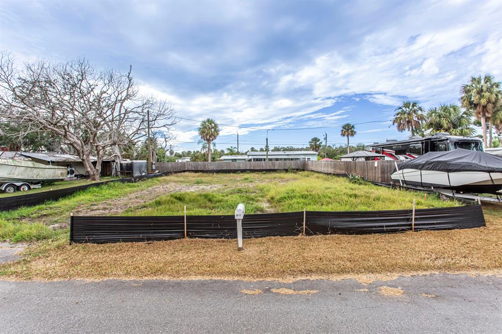 6813 Garden Drive New Port Richey, FL 34652 - Photo 8 of 8 a view of a swimming pool with a lawn chairs and a big yard