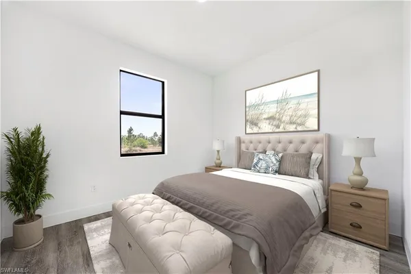 a bedroom with a bed and a potted plant