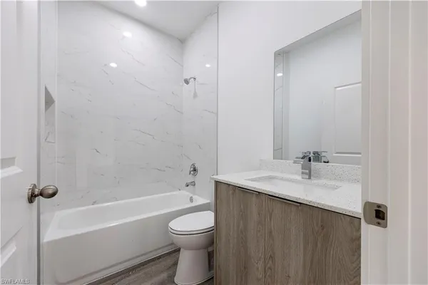 a bathroom with a sink a toilet and bathtub