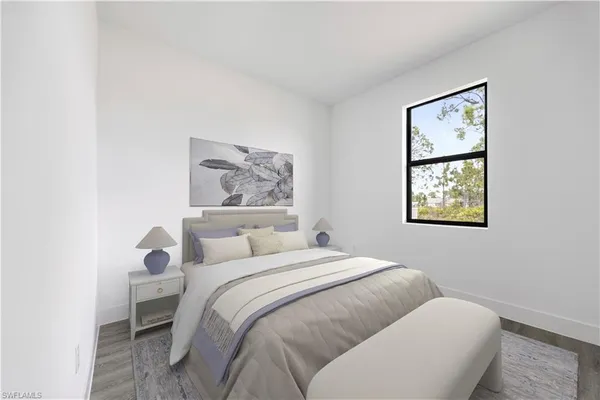 a bedroom with a bed and a painting on the wall