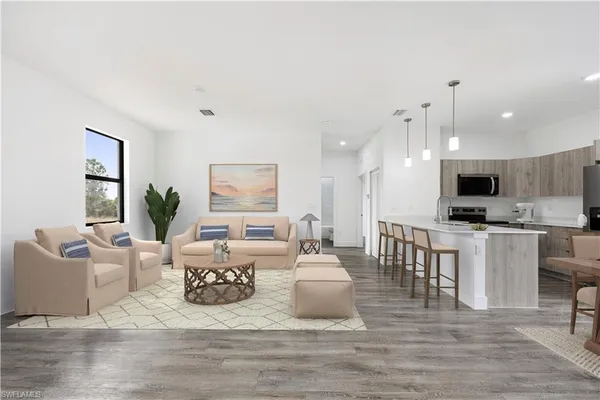 a living room with kitchen island furniture and a kitchen view
