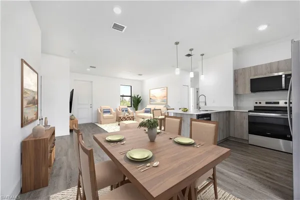 a view of a dining room with furniture and wooden floor