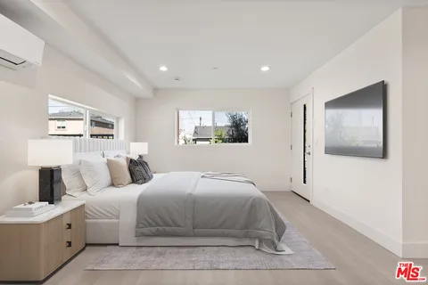 a bedroom with a large bed and a couch