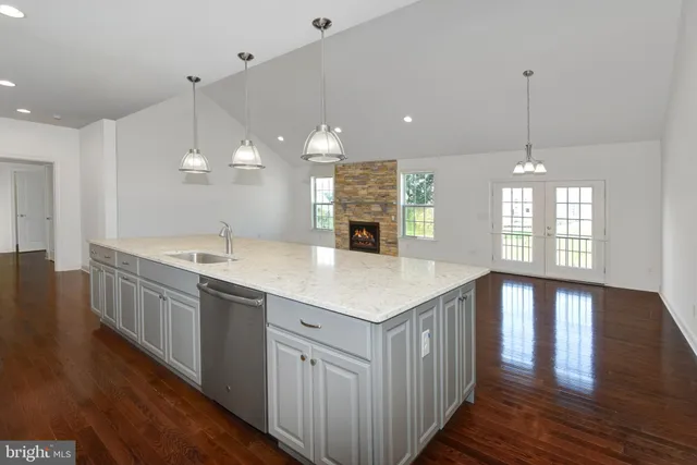 a kitchen with kitchen island sink stove and cabinets