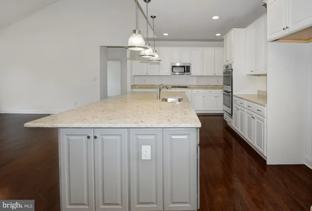 a view of kitchen with cabinets and wooden floor