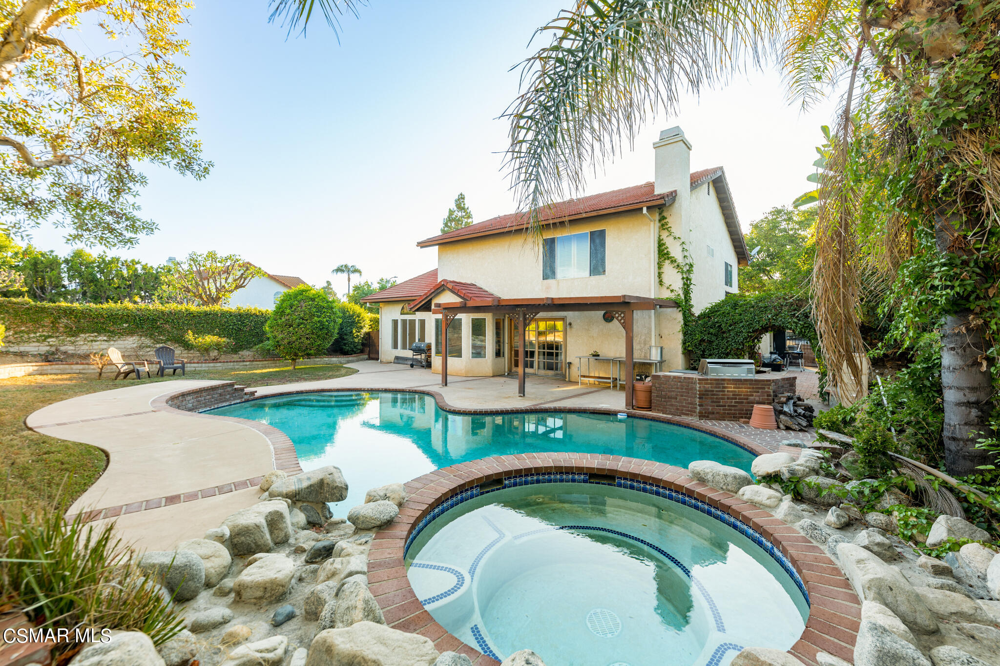 a house with swimming pool in front of it